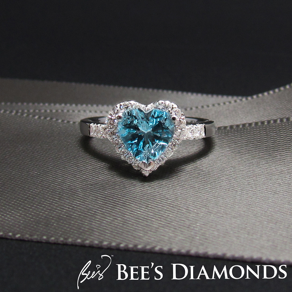 Aquamarine heart shape engagement ring with small diamonds around